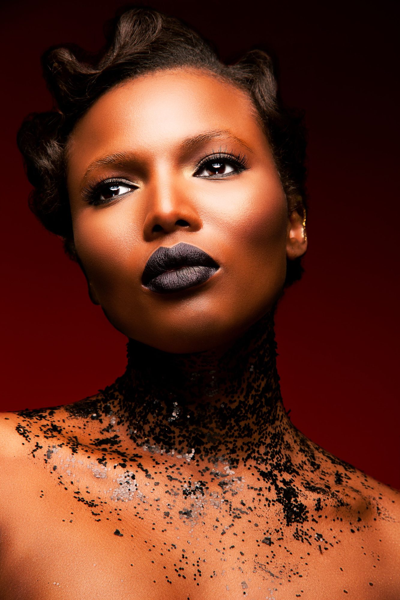 Beauty portrait with dark lips and black glitter on the neck