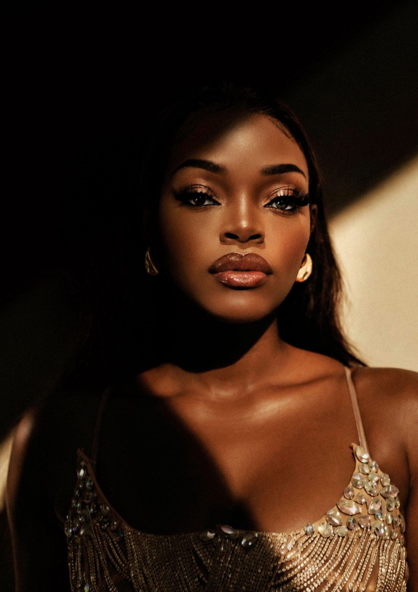Woman in gold sequins in warm low light