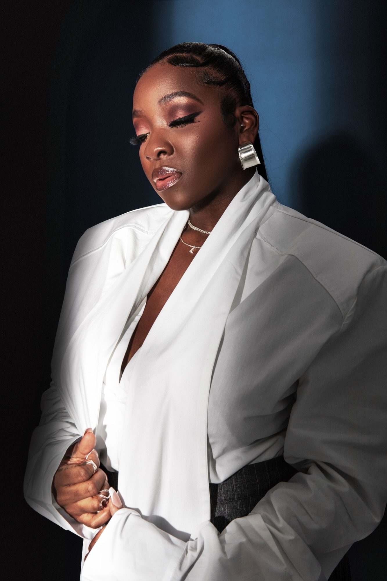Woman in a white suit in soft window light