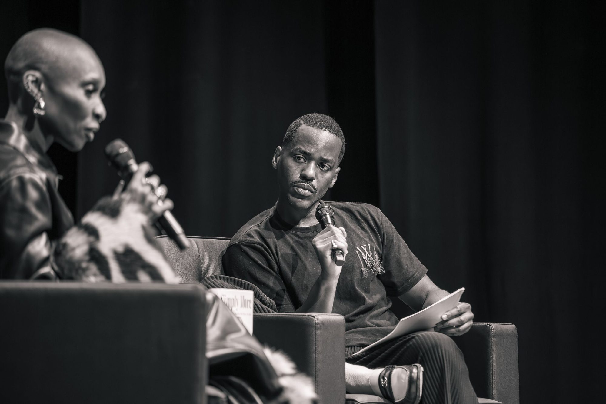 Black and white photo of an in conversation event on stage