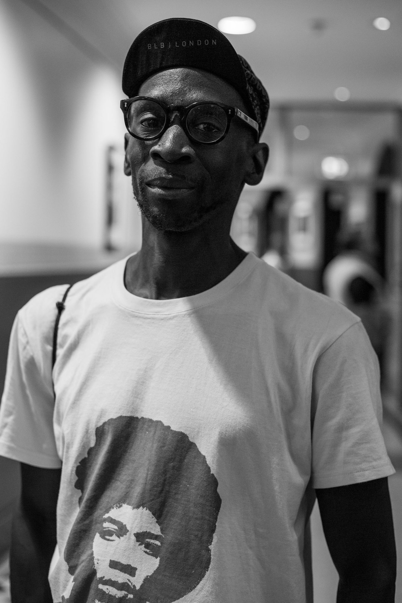 Black and white portrait of a man in a beanie and glasses