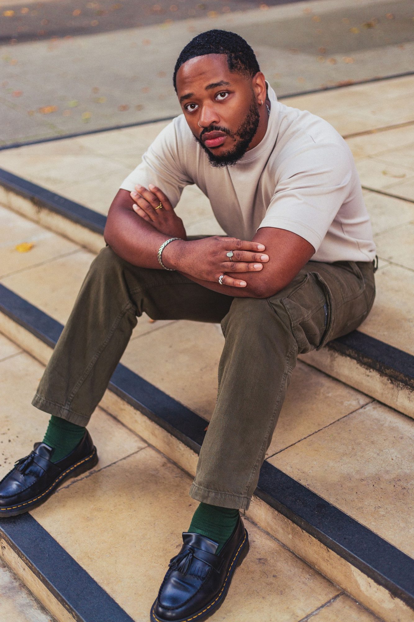 Man in a cream outfit sitting on stone steps