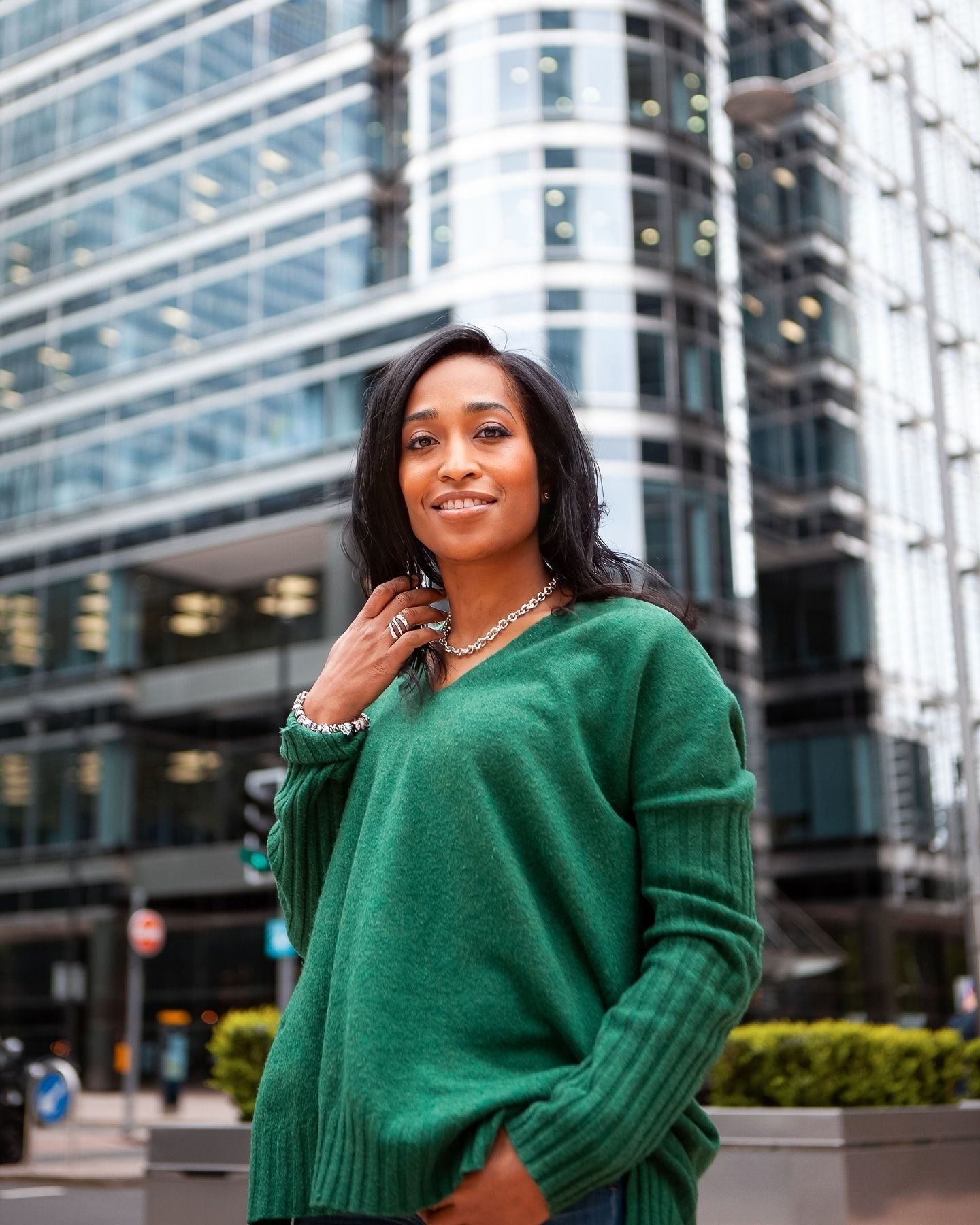 Woman in a green jumper on a city street