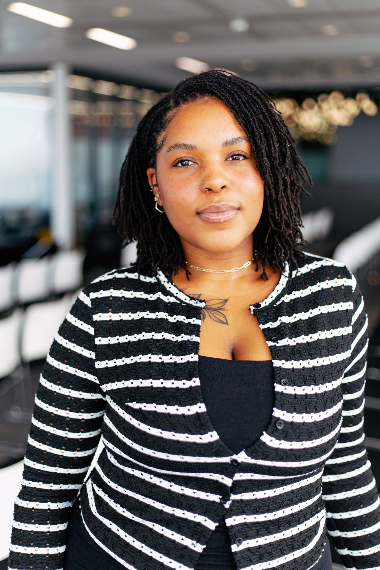 Woman in a black and white striped cardigan in an office